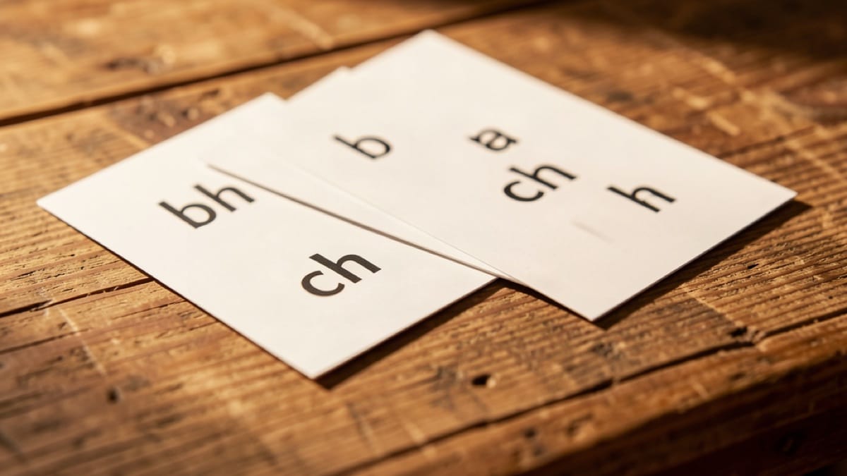 Gaelic word cards showing lenited consonants on a wooden table